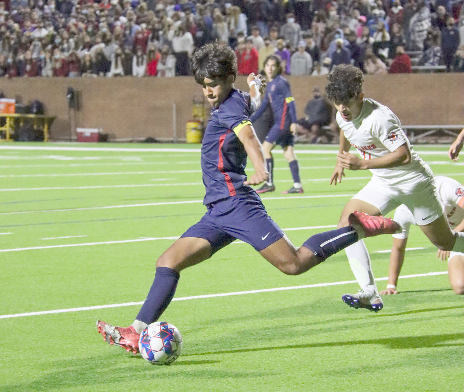 Tompkins junior Rafa Gonzales (8) prepares to kick the ball downfield during the Falcons’ Class 6A regional quarterfinal win over Seven Lakes on Friday, April 2, at Rhodes Stadium.